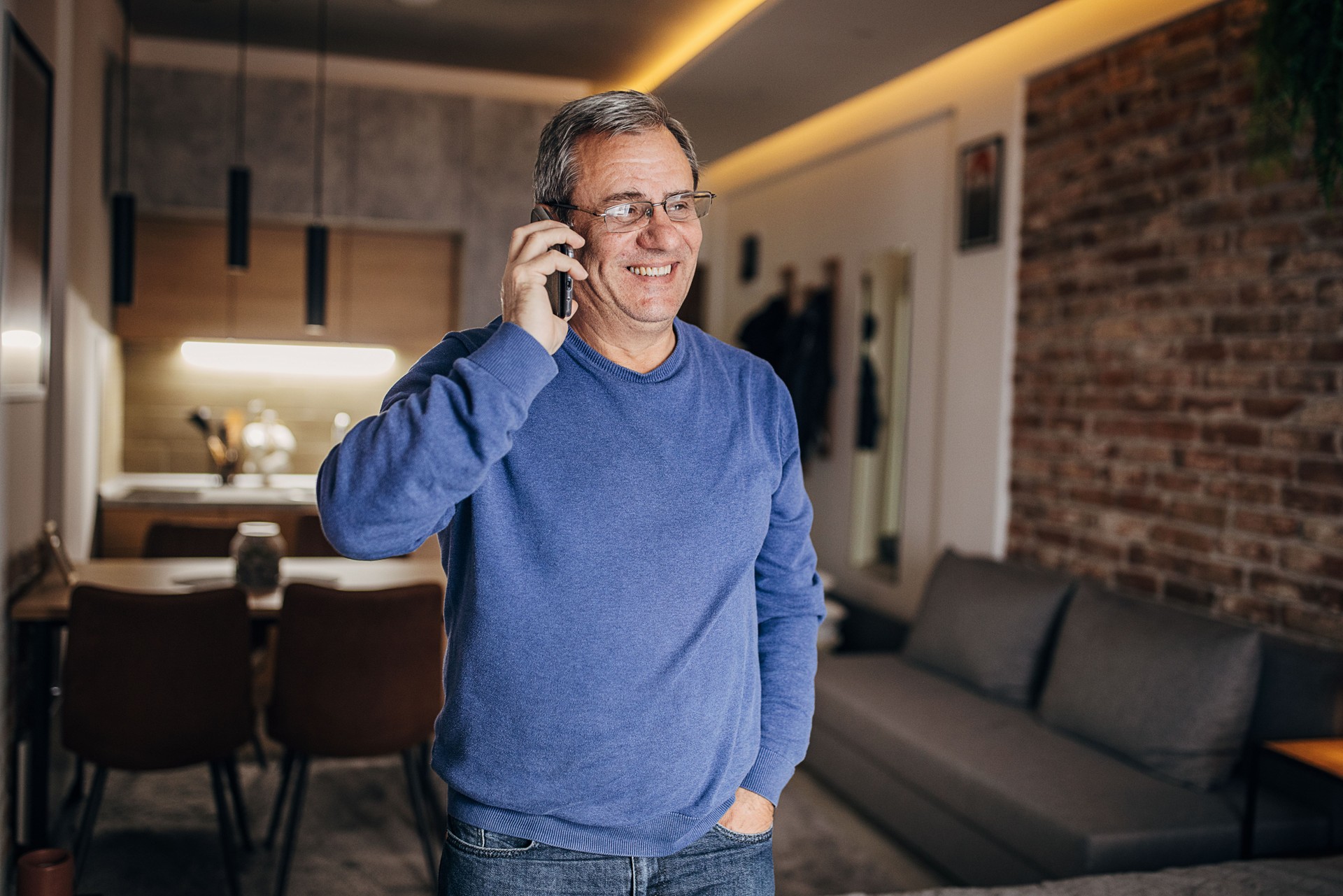 An older man uses a smartphone at home